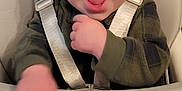 Mccoy joined the competition — help win amazing prizes! baby, high_chair, child, smiling, laughing, indoor, straps, green_clothing, face, mouth_open, happy, person, seat, hand, furniture, living_room, toy, floor, carpet, seat_belt