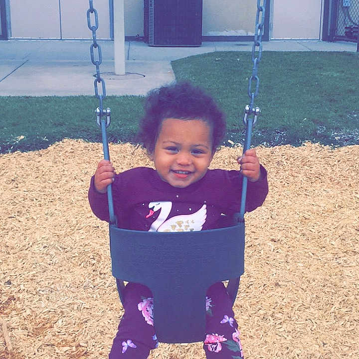Jazlyn joined the competition — help win amazing prizes! child, joy, outdoor_play_equipment, person, play, playground, public_space, recreation, smile, swing, toddler