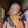 baby, sleeping, car_seat, overalls, harness, child, infant, safety, cute, peaceful, clothing, seatbelt, resting, young_child, portrait, indoors, small_child, person, baby_boy, comfort