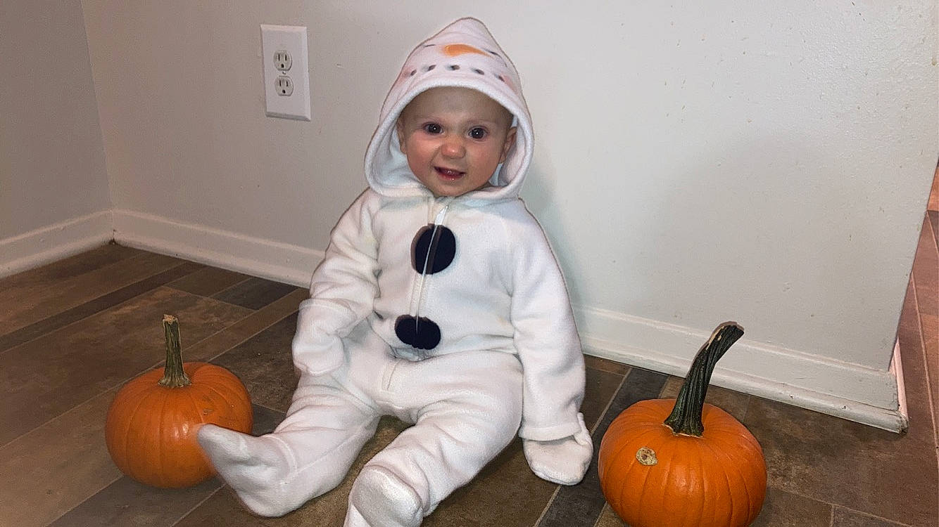 Haisley joined the competition — help win amazing prizes! calabaza, child, cucurbita, flooring, gourd, headwear, jack_o_lantern, natural_foods, orange, person, picture_frame, plant, pumpkin, room, sitting, smile, squash, toddler, trick_or_treat, vegetable