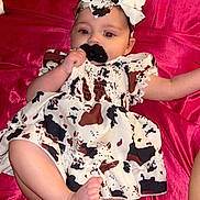 Iris is registered to the contest to win money with this photo: baby, pacifier, dress, headband, bow, infant, lying_down, pink_background, baby_bottle, baby_wipes, skin, foot, arm, clothing, fabric, child, cute, indoor, person, newborn