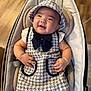 baby, infant, smiling, tweed_dress, hat, baby_seat, cushion, comfortable, happy, cute, chubby_cheeks, indoor, wooden_floor, clothing, child, portrait, person, adorable, seat, fashion