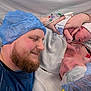 baby, beard, bed, closeup, family, father, gown, hand, healthcare, hospital, love, medical, mother, newborn, patient, person, skin, smile, surgical_cap, towel