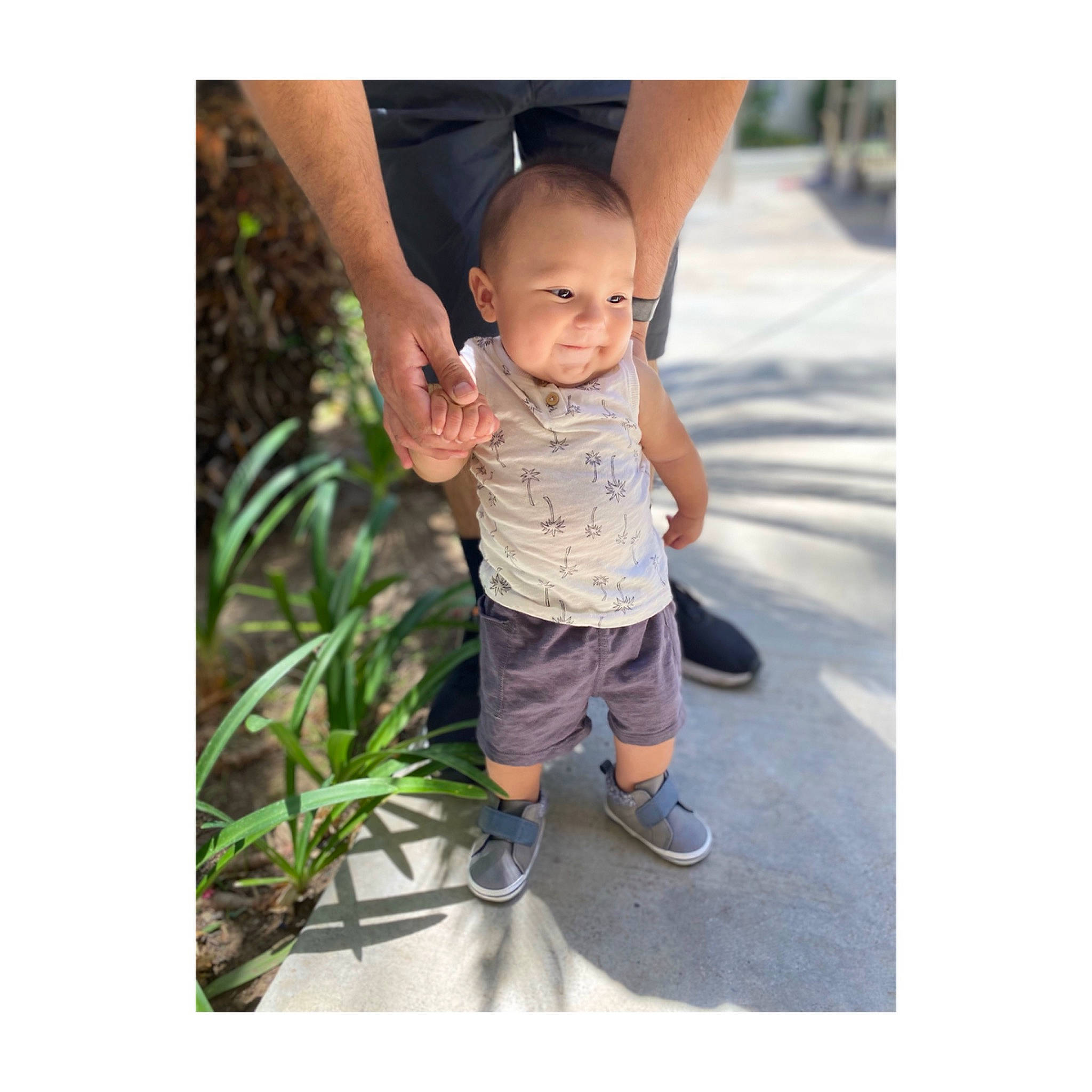 Dominik is registered to the contest to win money with this photo: baby, child, denim, footwear, gesture, grass, happy, leisure, people_in_nature, person, photo_caption, plant, recreation, sandal, shorts, sitting, sleeve, smile, stock_photography, t_shirt