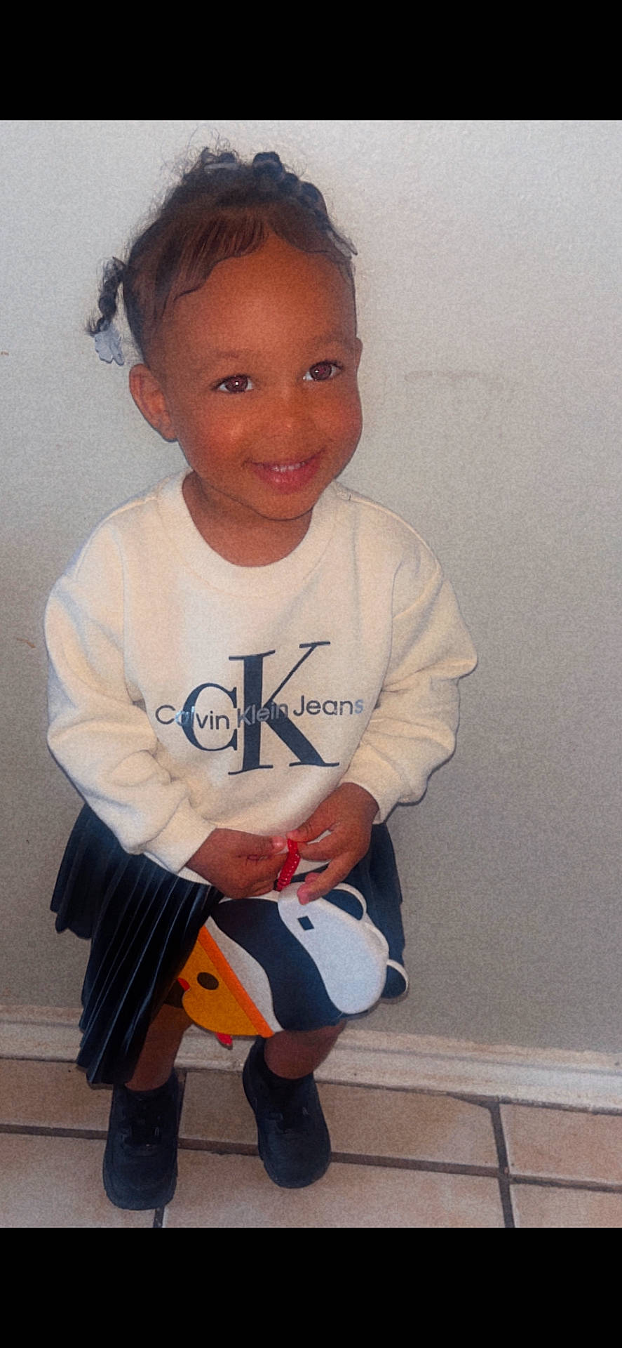 Leilani joined the competition — help win amazing prizes! bathroom, bodypart, clothing, face, finger, footwear, hand, head, indoors, knitwear, longsleeve, pants, person, photography, portrait, room, shoe, sitting, sleeve, sweater