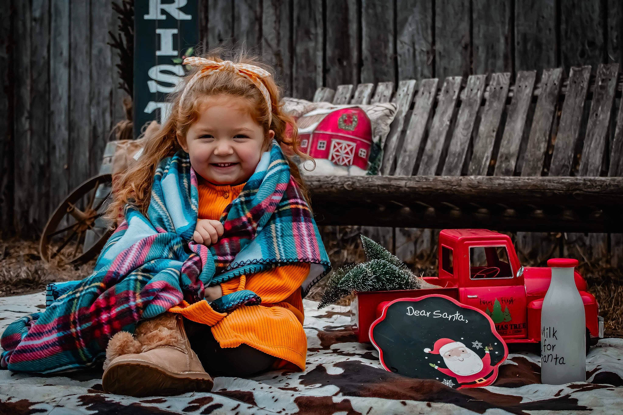 Hadley is registered to the contest to win money with this photo: asphalt, automotive_tire, carmine, child, fashion_accessory, fun, grass, happy, jacket, joy, leisure, people_in_nature, person, power_tool, recreation, road_surface, sitting, smile, soil, toddler