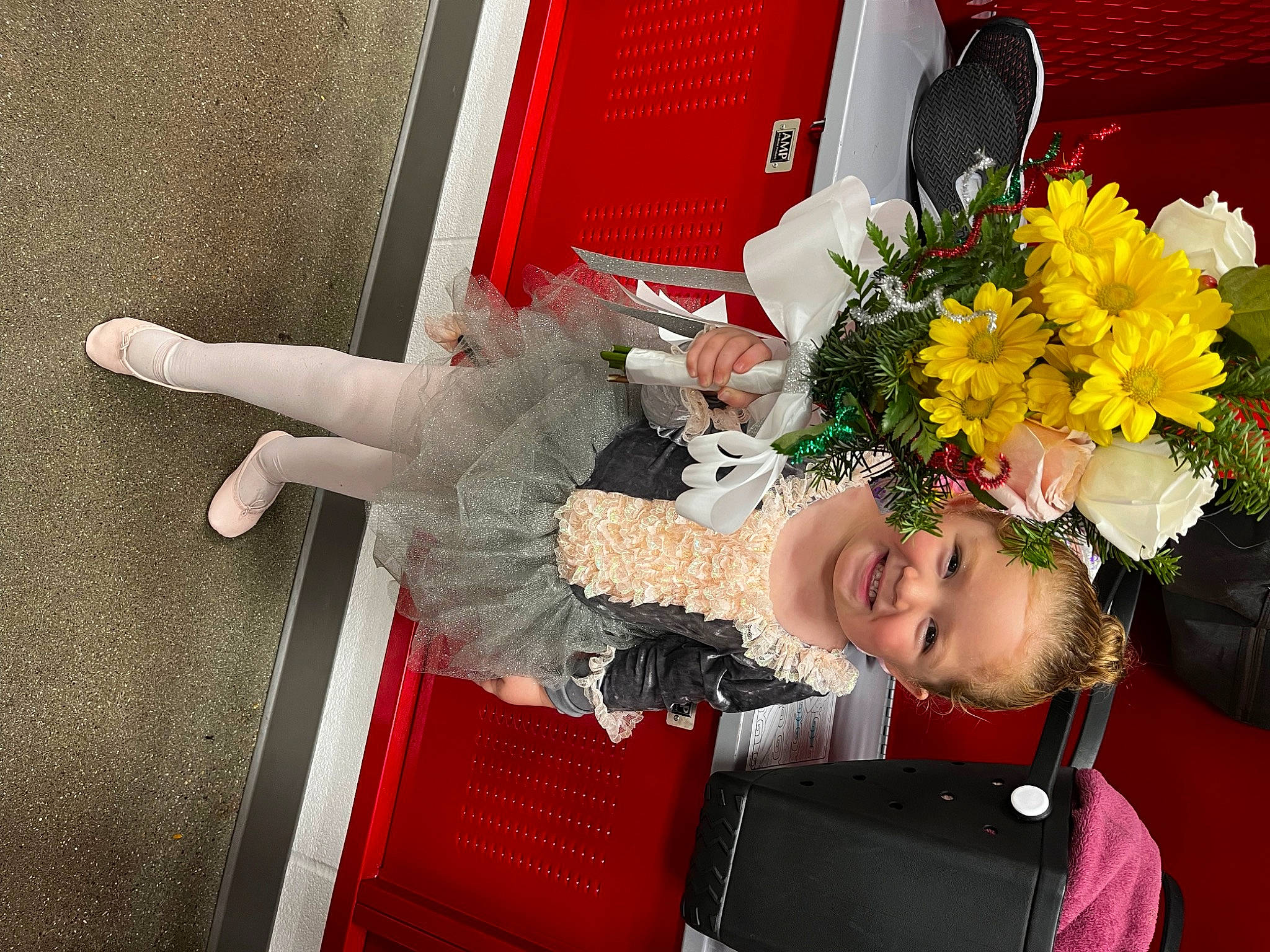 Hadley is registered to the contest to win money with this photo: artificial_flower, baby, bouquet, child, cut_flowers, event, floral_design, floristry, flower, flower_arranging, flowerpot, happy, joy, lap, person, petal, plant, red, rose, sitting