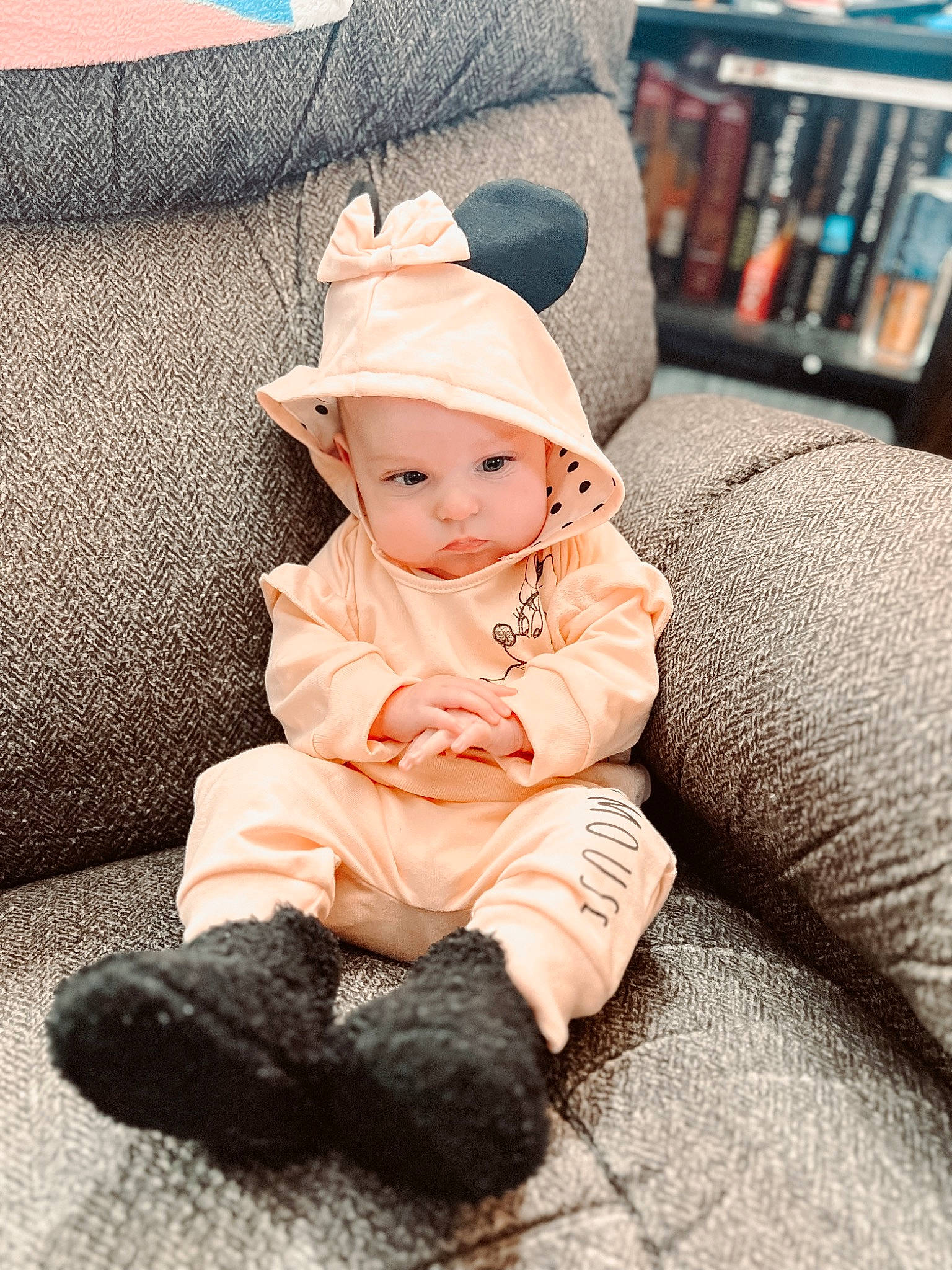 Koda joined the competition — help win amazing prizes! baby, baby_toddler_clothing, bookcase, cap, child, comfort, face, fashion_accessory, fur, hat, headwear, linens, pattern, person, shelf, shelving, sitting, sleeve, sun_hat, textile