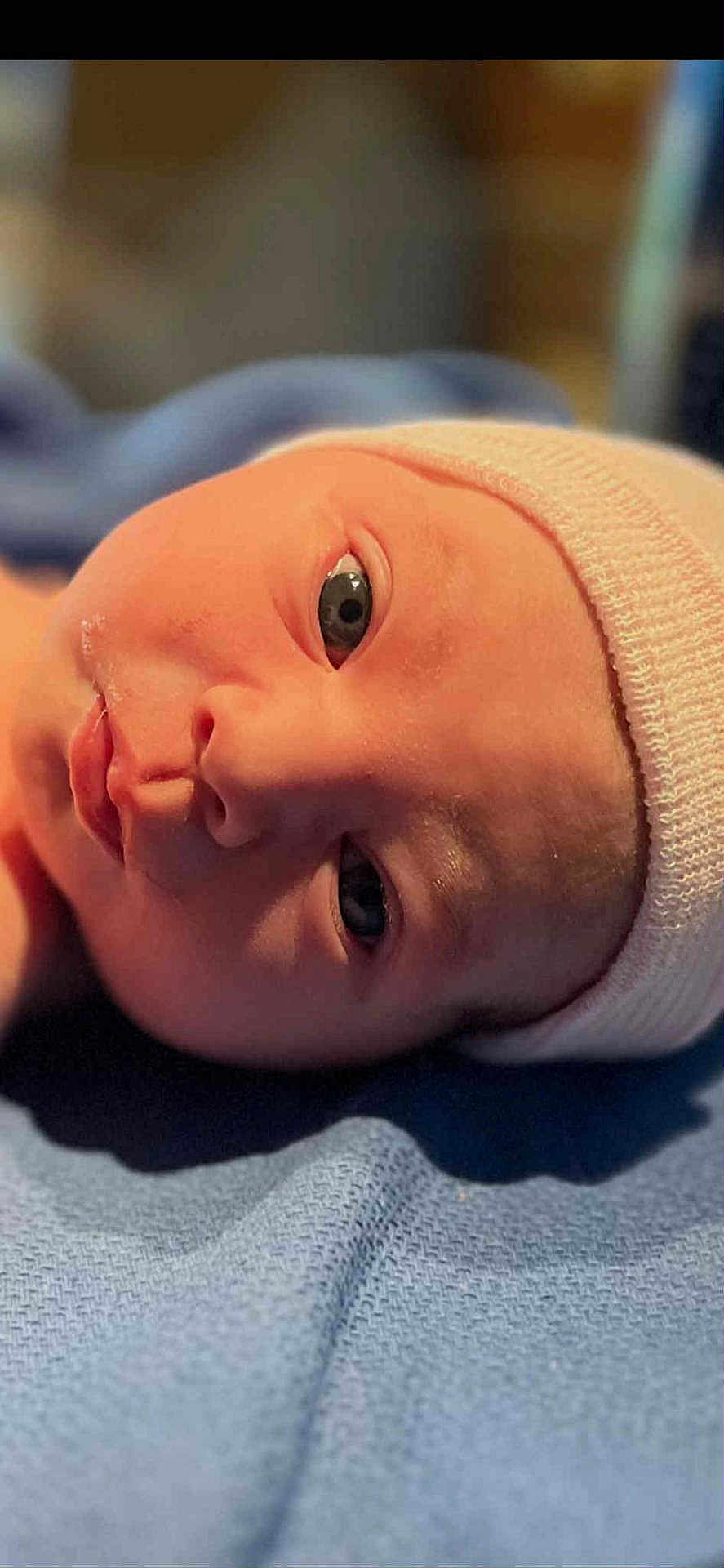 Heidi joined the competition — help win amazing prizes! newborn, baby, infant, face, closeup, cap, blue_blanket, skin, eyes, headwear, soft_lighting, portrait, lying_down, cute, child, small, young, sleepy, indoors, warm