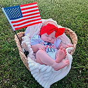 Ottalee Jo joined the competition — help win amazing prizes! baby, basket, blanket, grass, outdoor, flag, headband, red_bow, sleeping, infant, patriotic, foot, clothing, nature, peaceful, summer, countryside, relaxing, resting, portrait