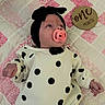 baby, infant, pacifier, headband, bow, polka_dot, sweater, quilt, pink, white, black, sign, wooden_sign, one_month, lying_down, cute, newborn, child, portrait, indoors