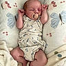 baby, newborn, pacifier, sleeping, blanket, butterfly_pattern, infant, cute, soft_texture, cozy, clothing, arms_up, lying_down, pastel_colors, child, peaceful, indoors, person, sleep, wrapped