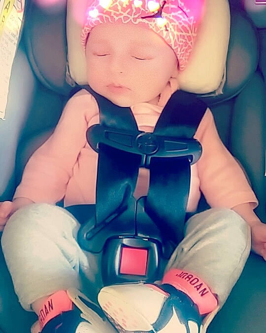 Aubrie is registered to the contest to win money with this photo: arm, baby, beauty, car_seat, cheek, child, cool, ear, fashion_accessory, finger, hand, happy, human, leg, love, person, photography, pink, product, sitting