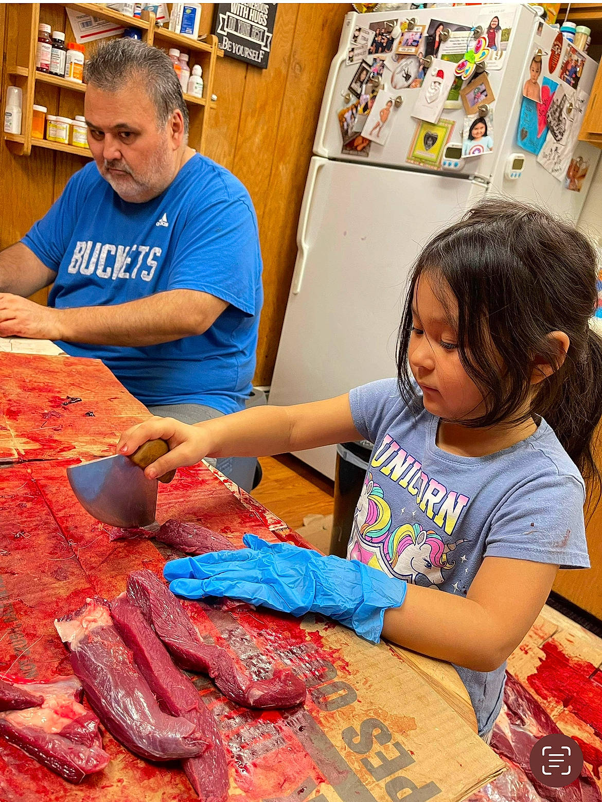 Liv is registered to the contest to win money with this photo: art, artist, beef, chair, cuisine, customer, event, flesh, leisure, longaniza, market, meat, person, recreation, red_meat, retail, room, sharing, t_shirt, toddler