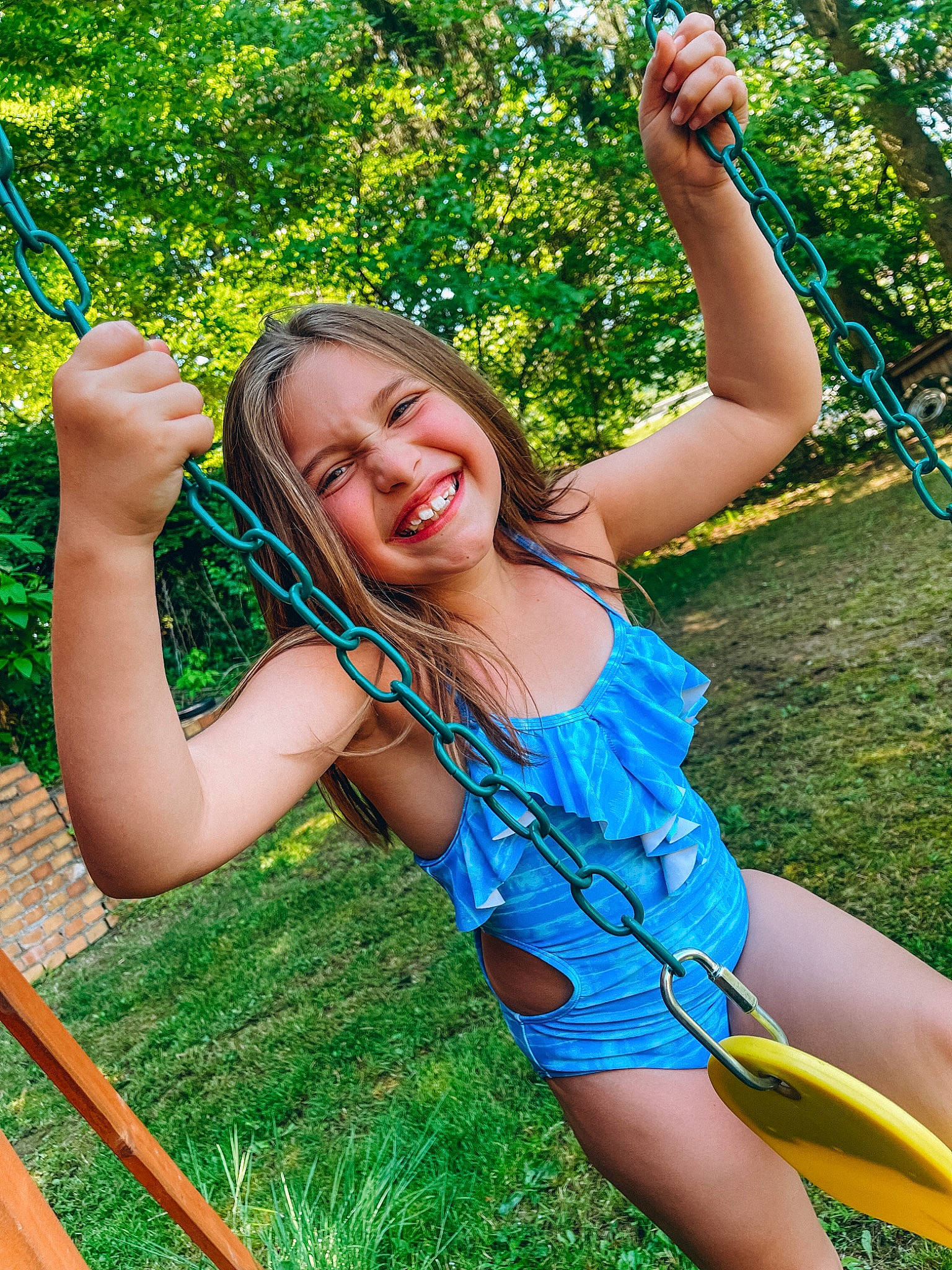 Haylie is registered to the contest to win money with this photo: facial_expression, finger, flash_photography, fun, gesture, grass, green, happy, joy, leaf, leg, leisure, muscle, people_in_nature, person, plant, shoulder, smile, sunlight, thigh