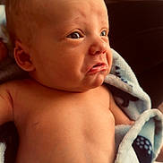 Sawyer joined the competition — help win amazing prizes! baby, blanket, child, cute, expression, face, hair, head, indoors, infant, mohawk, newborn, person, pout, skin, soft, torso, warm, wrapped, young