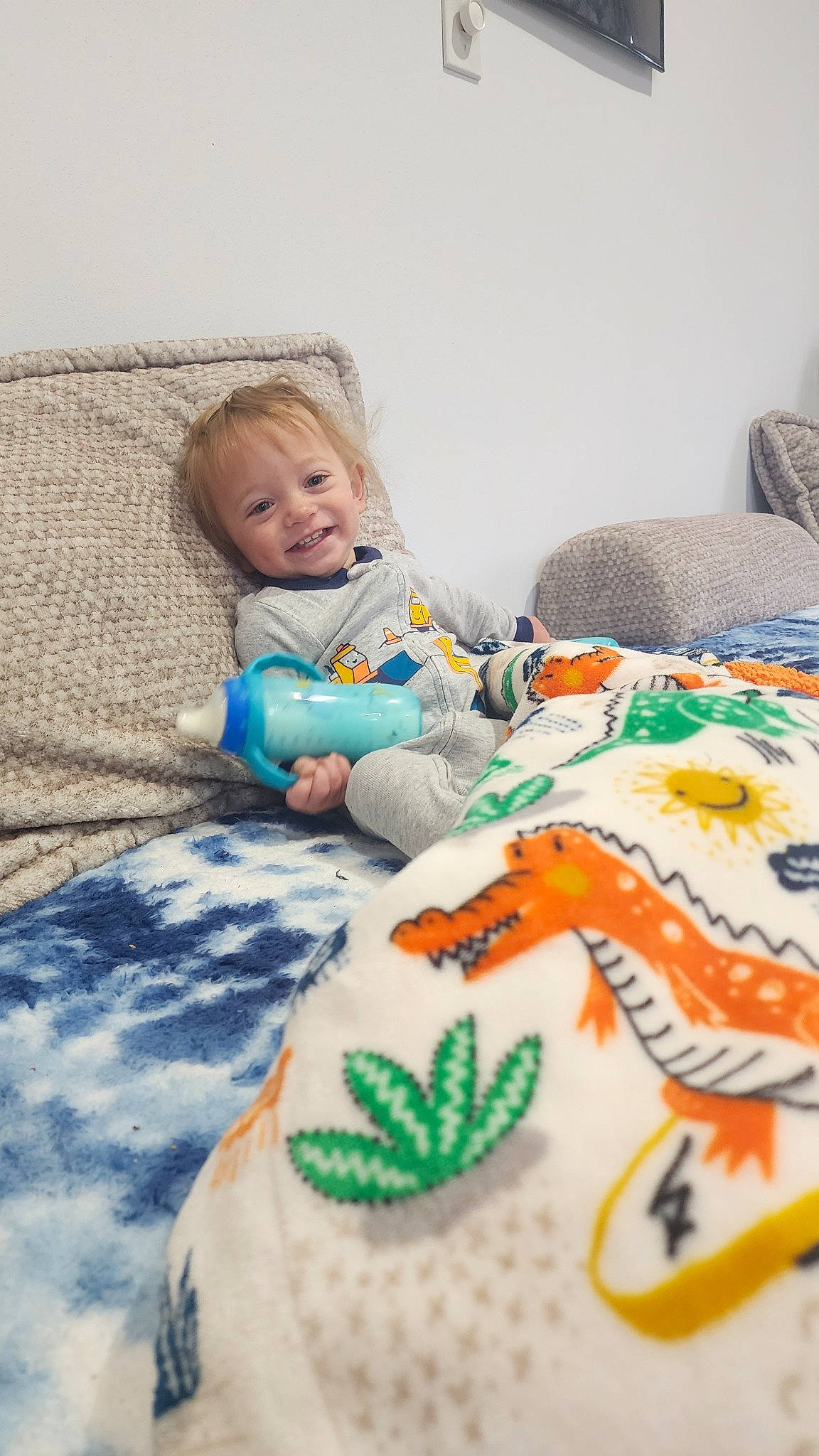 Braydon is registered to the contest to win money with this photo: art, baby, baby_toddler_clothing, bedding, child, comfort, flooring, fun, grass, happy, joy, leisure, linens, pattern, person, product, sleeve, smile, t_shirt, textile