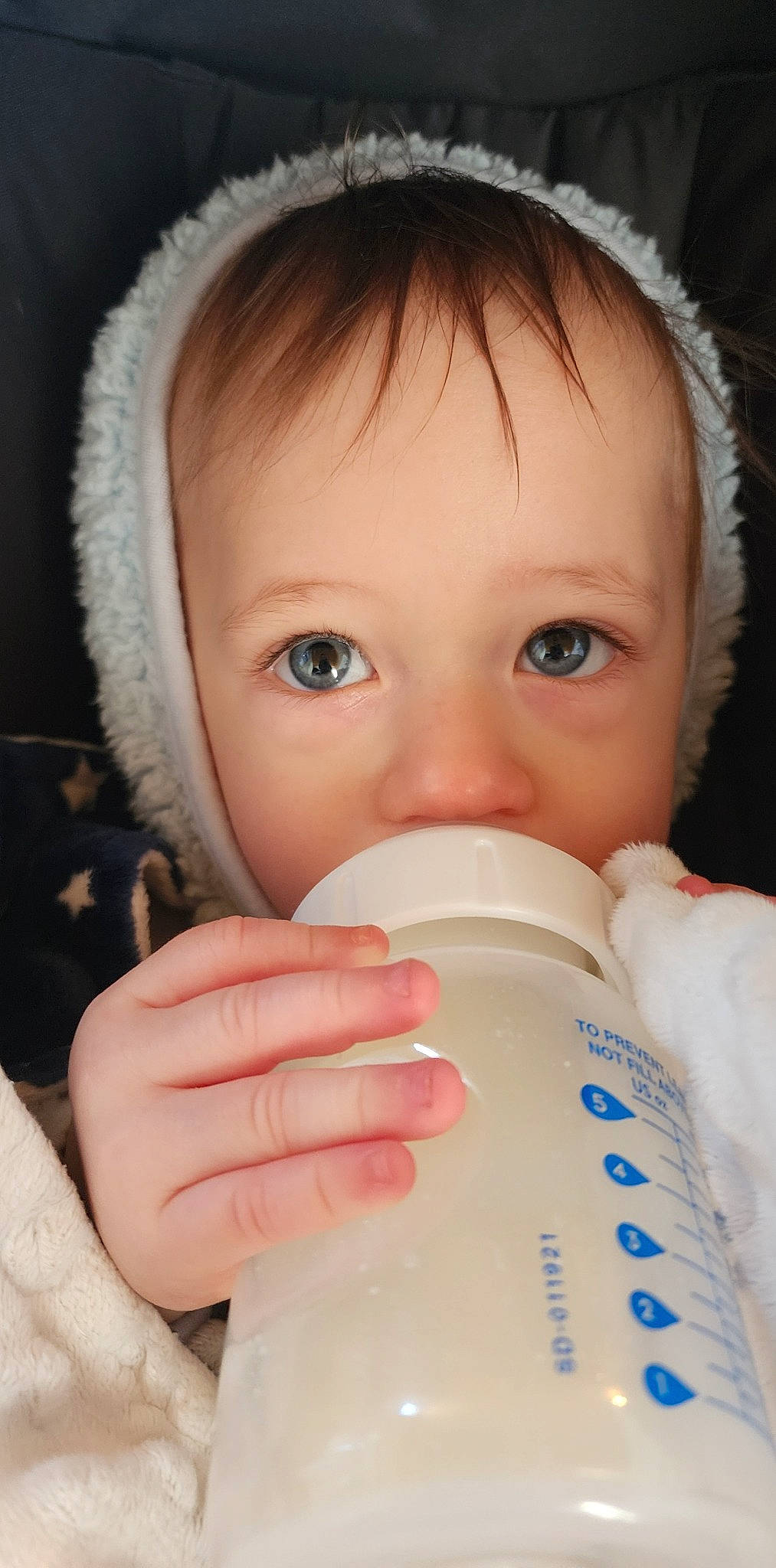Buckley joined the competition — help win amazing prizes! baby, baby_bottle, bottle, cheek, chin, drinkware, ear, eyebrow, eyelash, finger, fluid, hand, lip, liquid, nose, organ, person, plastic_bottle, skin, toddler