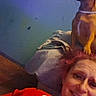 Layla Rose Morris is registered to the contest to win money with this photo: blanket, casual, collar, cozy, dog, face, floor, furniture, head, home, indoor, looking_sideways, person, pet, portrait, red_clothing, relaxed, seated, smile, wall