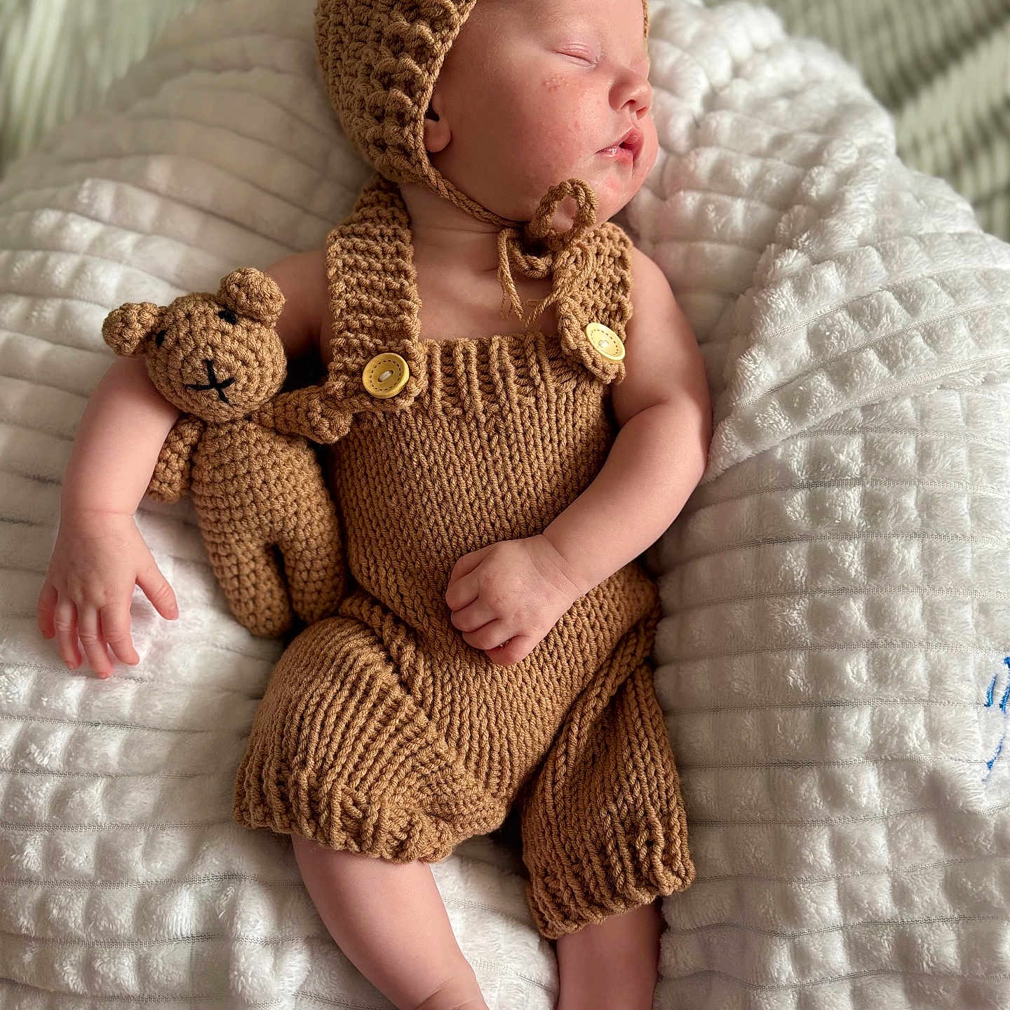 Jameson is registered to the contest to win money with this photo: baby, beanie, blanket, bonnet, cap, clothing, dress, face, furniture, glove, hat, head, knitwear, newborn, person, photography, portrait, sweater, teddybear, toy