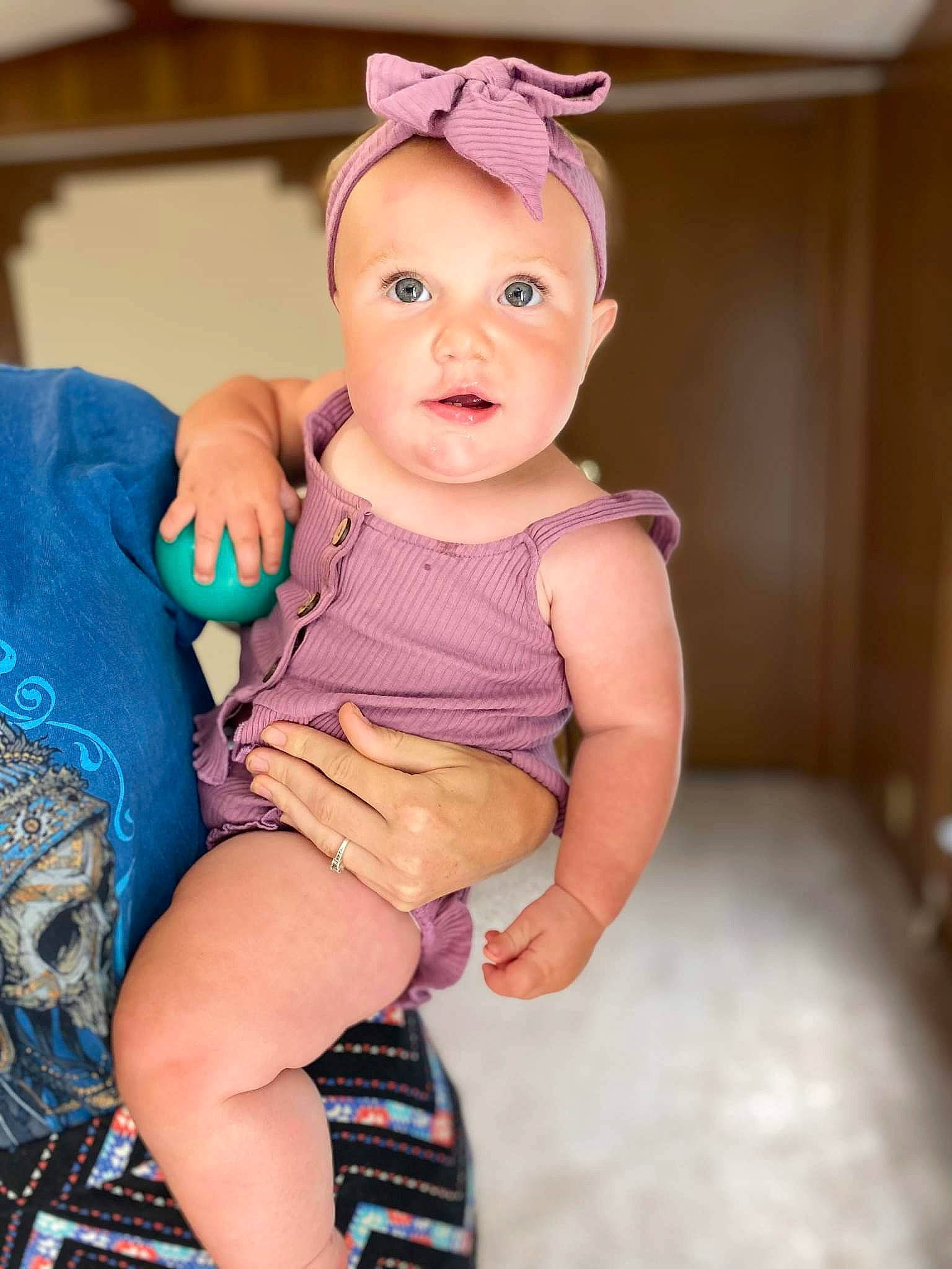 Lilac is registered to the contest to win money with this photo: baby, baby_toddler_clothing, dress, eye, eyelash, finger, happy, head, headgear, human_body, iris, lip, neck, person, pink, purple, shoulder, skin, sleeve, surprise
