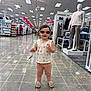 toddler, child, sunglasses, store, shopping, mannequin, clothing, aisle, floor, footwear, person, retail, casual_wear, tag, bracelet, pants, top, indoor, shopping_cart, display