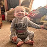 Mckenna joined the competition — help win amazing prizes! baby, child, infant, smiling, happy, sitting, portrait, indoors, home, carpet, clothing, gray_outfit, long_sleeves, bare_feet, furniture, chair, couch, sunlight, warm_lighting, photography
