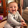 baby, bare_feet, child, eyes, face, furniture, gray_clothing, hands, happy, high_chair, home, indoor, infant, long_sleeves, open_mouth, photography, portrait, seated, smiling, wooden_chair