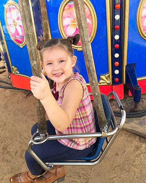 Emeri is registered to the contest to win money with this photo: blue, child, city, electric_blue, fun, happy, human_settlement, joy, leisure, outdoor_play_equipment, person, photograph, play, playground, recreation, smile, snapshot, summer, swing, toddler