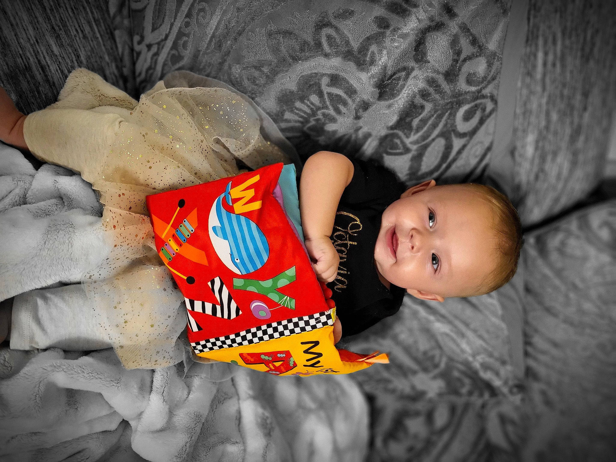 Octavia joined the competition — help win amazing prizes! baby, baby_products, baby_toddler_clothing, child, comfort, couch, flash_photography, fun, happy, linens, mouth, orange, pattern, person, room, sitting, skin, smile, t_shirt, textile