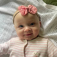 Sophia joined the competition — help win amazing prizes! adorable, baby, blanket, bow, cheeks, child, cute, eyes, face, headband, infant, lying_down, onesie, pink, portrait, smile, soft_lighting, striped_clothing, texture, white