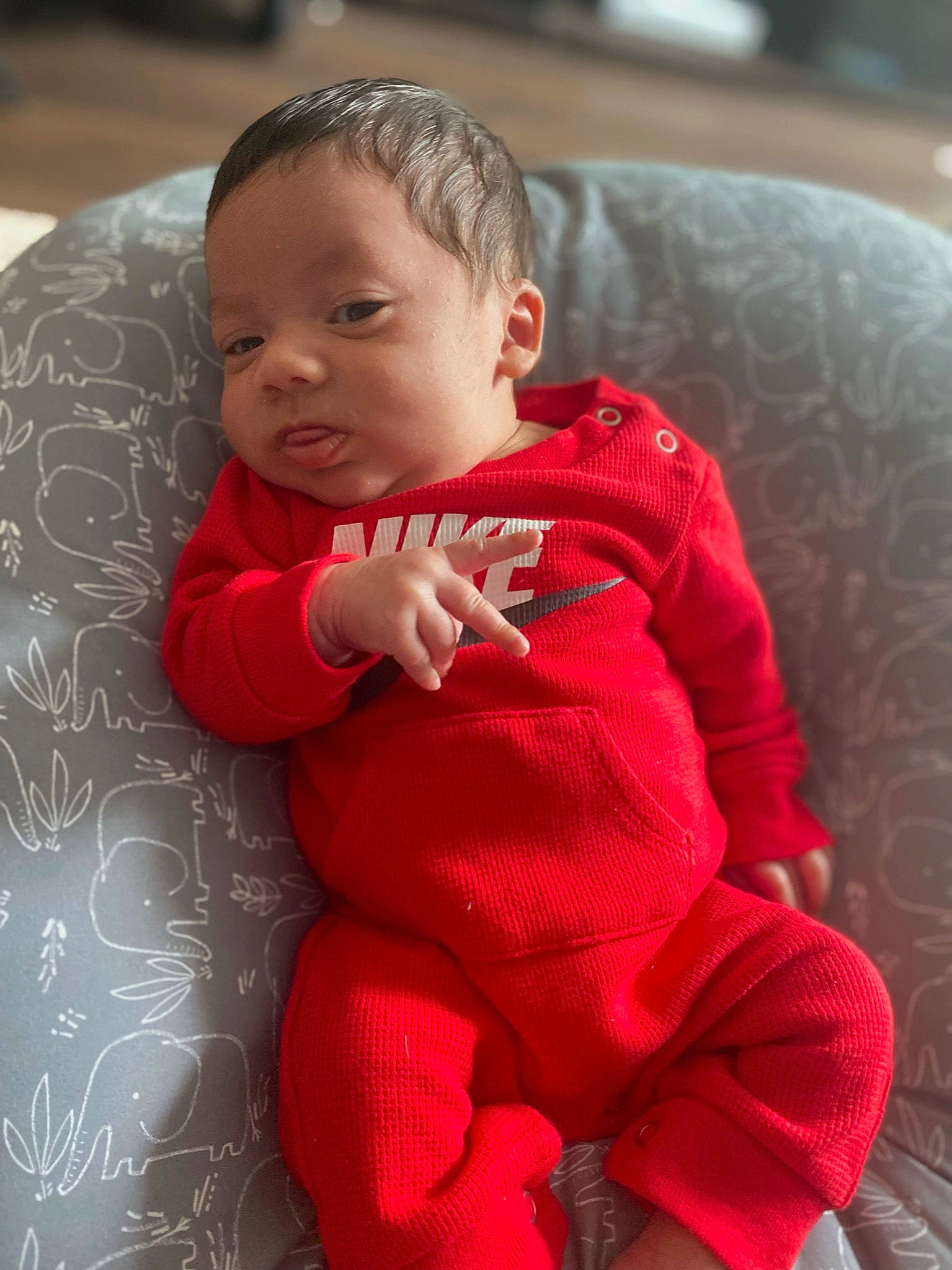 Cortez is registered to the contest to win money with this photo: arm, baby, baby_toddler_clothing, cheek, comfort, finger, flooring, hairstyle, hand, head, human_body, iris, lip, mouth, nose, person, pink, skin, sleeve, standing