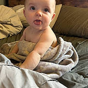 Kensley is registered to the contest to win money with this photo: baby, bed, blanket, child, comfort, cute, expression, face, head, indoors, infant, light, person, pillow, playful, skin, sleeping_area, soft, tongue, towel