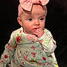 Kensley joined the competition — help win amazing prizes! baby, child, girl, headband, bow, pink, floral_dress, hand, fingers, face, blue_eyes, curious, portrait, infant, cute, sitting, clothing, pattern, background, indoor