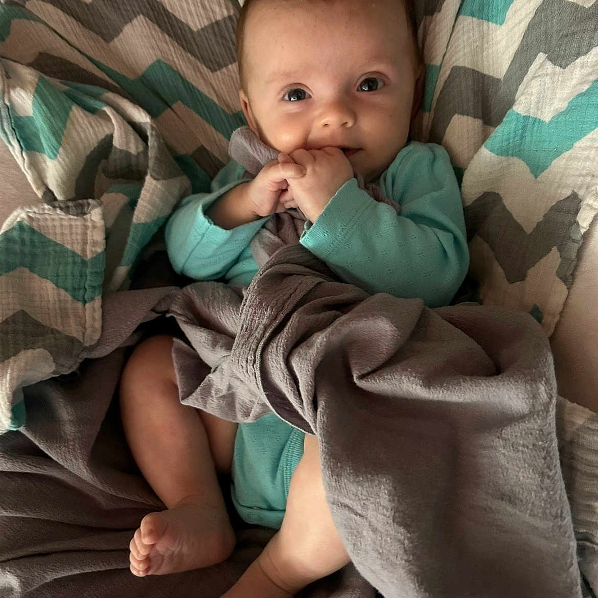 Kensley joined the competition — help win amazing prizes! baby, bed, blanket, child, clothing, comfort, cozy, cute, face, feet, hand, indoor, infant, plush_toy, portrait, relaxed, rest, smiling, soft_texture, warm