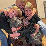 barefoot, black_shirt, blonde_hair, cage, camouflage_pants, casual_clothing, children, dog, door, family, floor, group, happy, home, hug, indoor, jeans, pet, short_hair, smiling