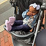 Zaria joined the competition — help win amazing prizes! toddler, child, stroller, denim_jacket, white_bow, headband, pink_socks, curly_hair, outdoor, sidewalk, brick, urban, baby, baby_accessory, seatbelt, cute, person, footwear, casual_clothing, resting