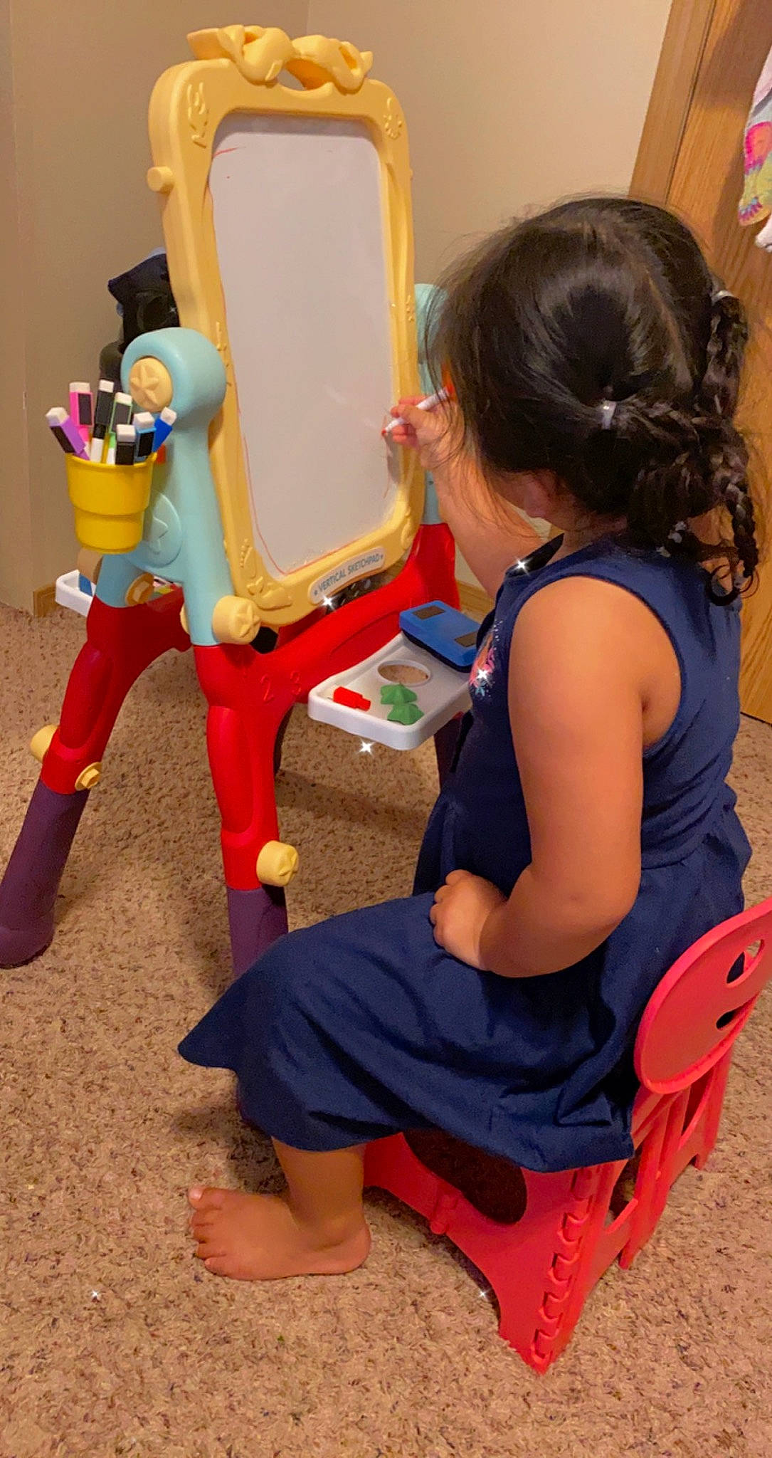 Jenisa is registered to the contest to win money with this photo: arm, blue, chair, child, community, fun, hand, human_body, human_leg, joint, leg, leisure, organ, person, play, ponytail, recreation, sitting, thigh, toddler