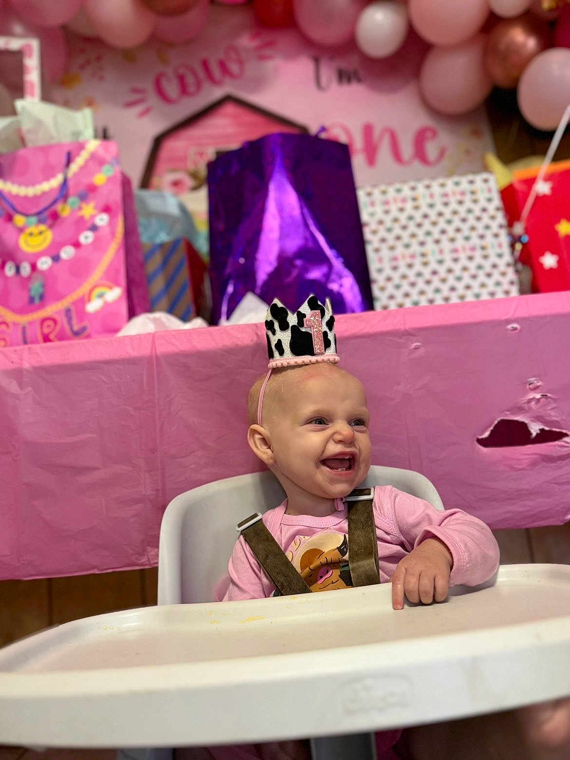 Wrenlee joined the competition — help win amazing prizes! baby, child, high_chair, birthday, party, crown, smile, pink, gift_bags, balloons, celebration, happy, infant, clothing, table, face, person, young_child, indoor, event