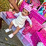 Analaya is registered to the contest to win money with this photo: child, toddler, birthday, party, presents, pink, crown, celebration, outdoor, table, gift, smiling, person, hand, balloon, decorations, happy, cute, clothing, footwear