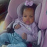 baby, child, car_seat, pink, purple, bow, clothing, jeans, footwear, car_interior, seatbelt, portrait, infant, person, cute, serious_face, sitting, vehicle, casual, accessory