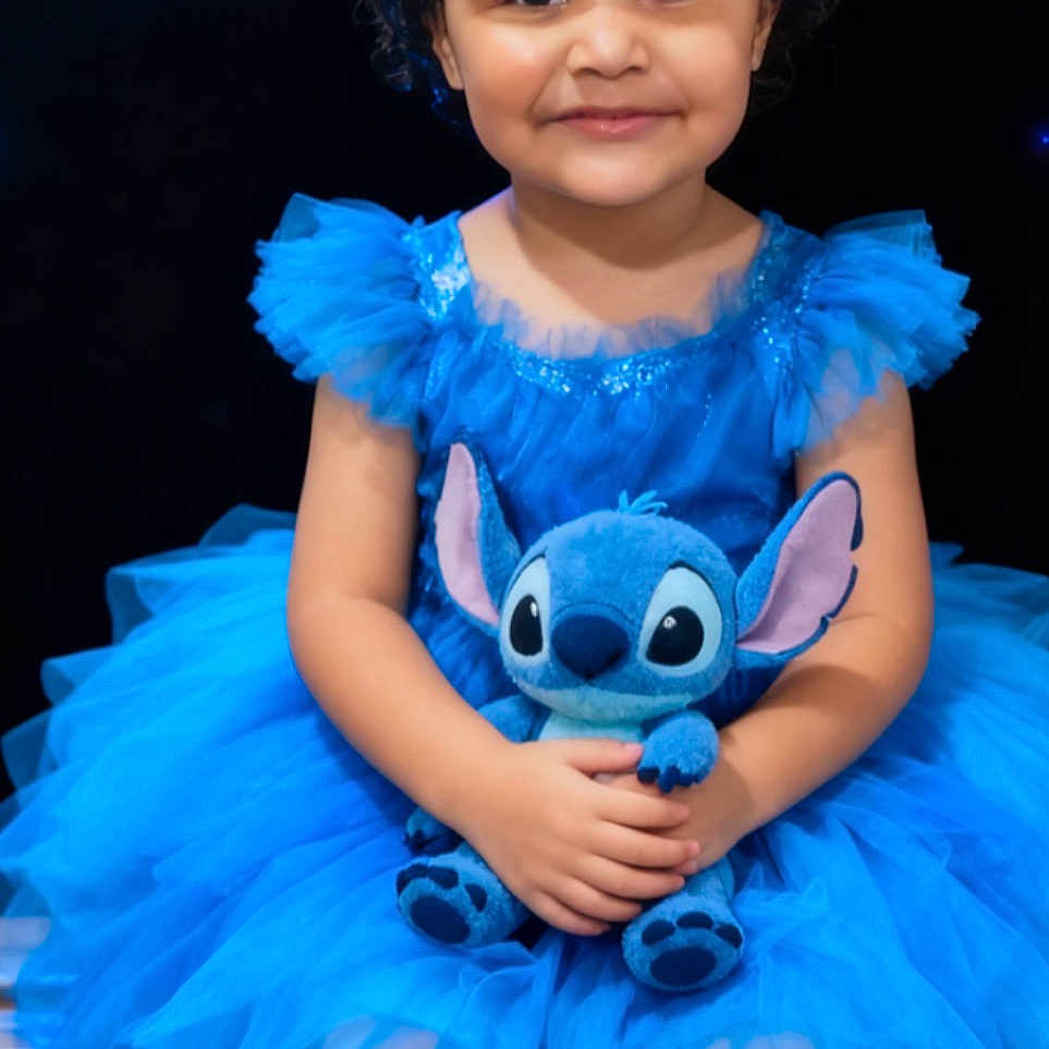 Charlotte joined the competition — help win amazing prizes! child, girl, blue_dress, tutu, curly_hair, silver_bows, plush_toy, stitch, bench, smile, portrait, sitting, cute, happy, indoor, dark_background, toy, childhood, person, fashion