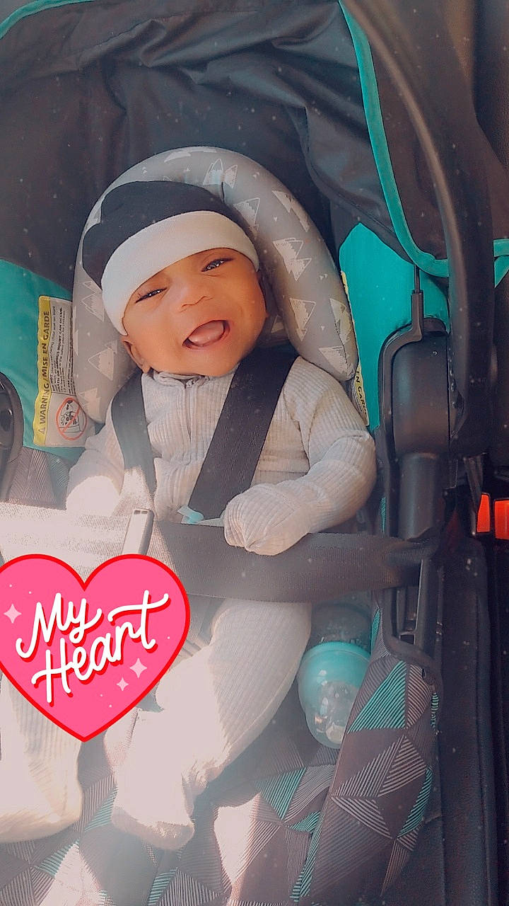 Jeremiah is registered to the contest to win money with this photo: baby, baby_carriage, baby_products, cap, car_seat, car_seat_cover, carmine, child, comfort, cool, event, facial_expression, family_car, font, fun, happy, headwear, person, skin, smile