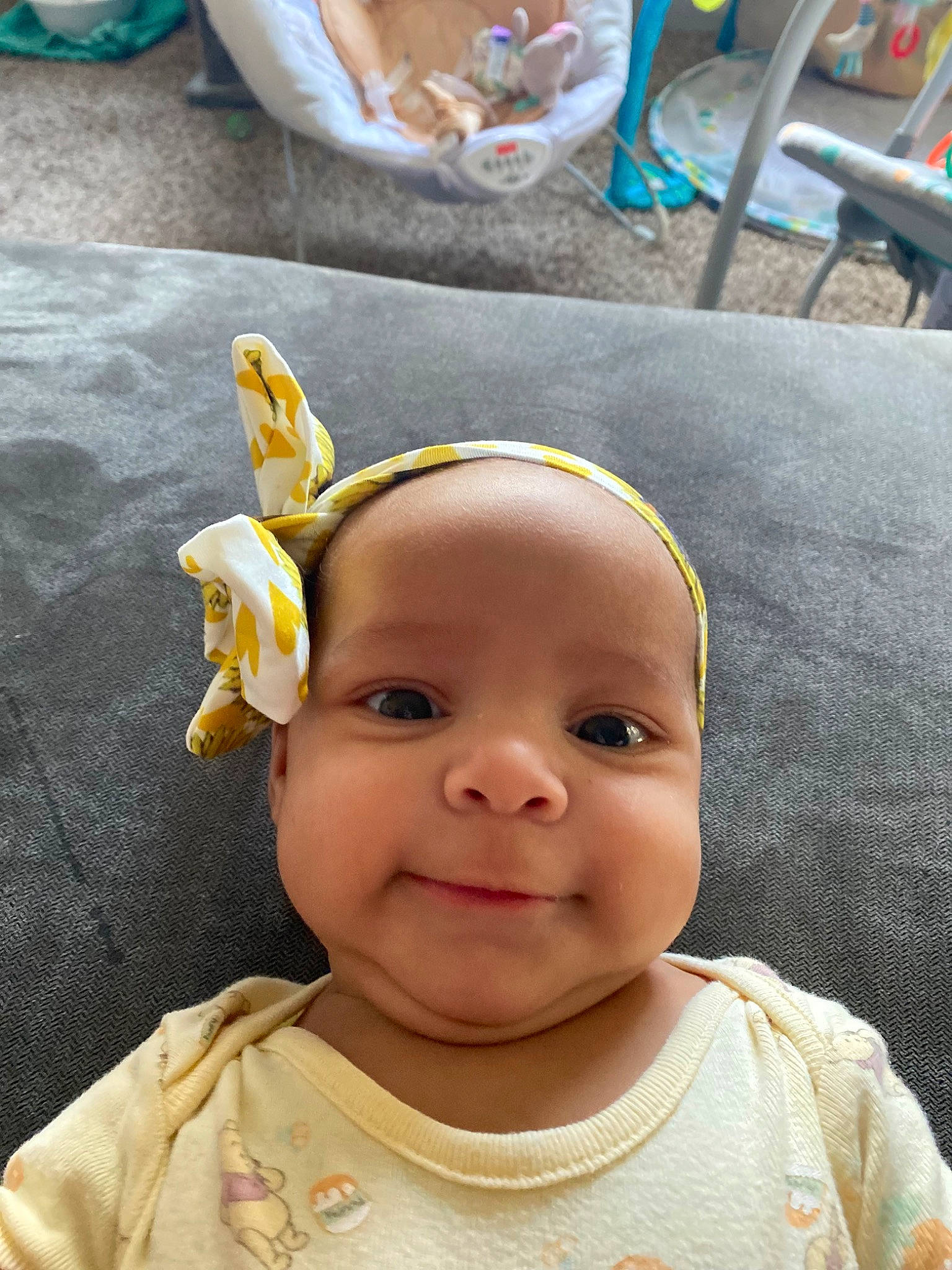 Gaia is registered to the contest to win money with this photo: baby, baby_toddler_clothing, cheek, child, ear, eye, eyebrow, eyelash, fashion_accessory, forehead, fun, green, hair_accessory, happy, iris, nose, person, sleeve, smile, toddler