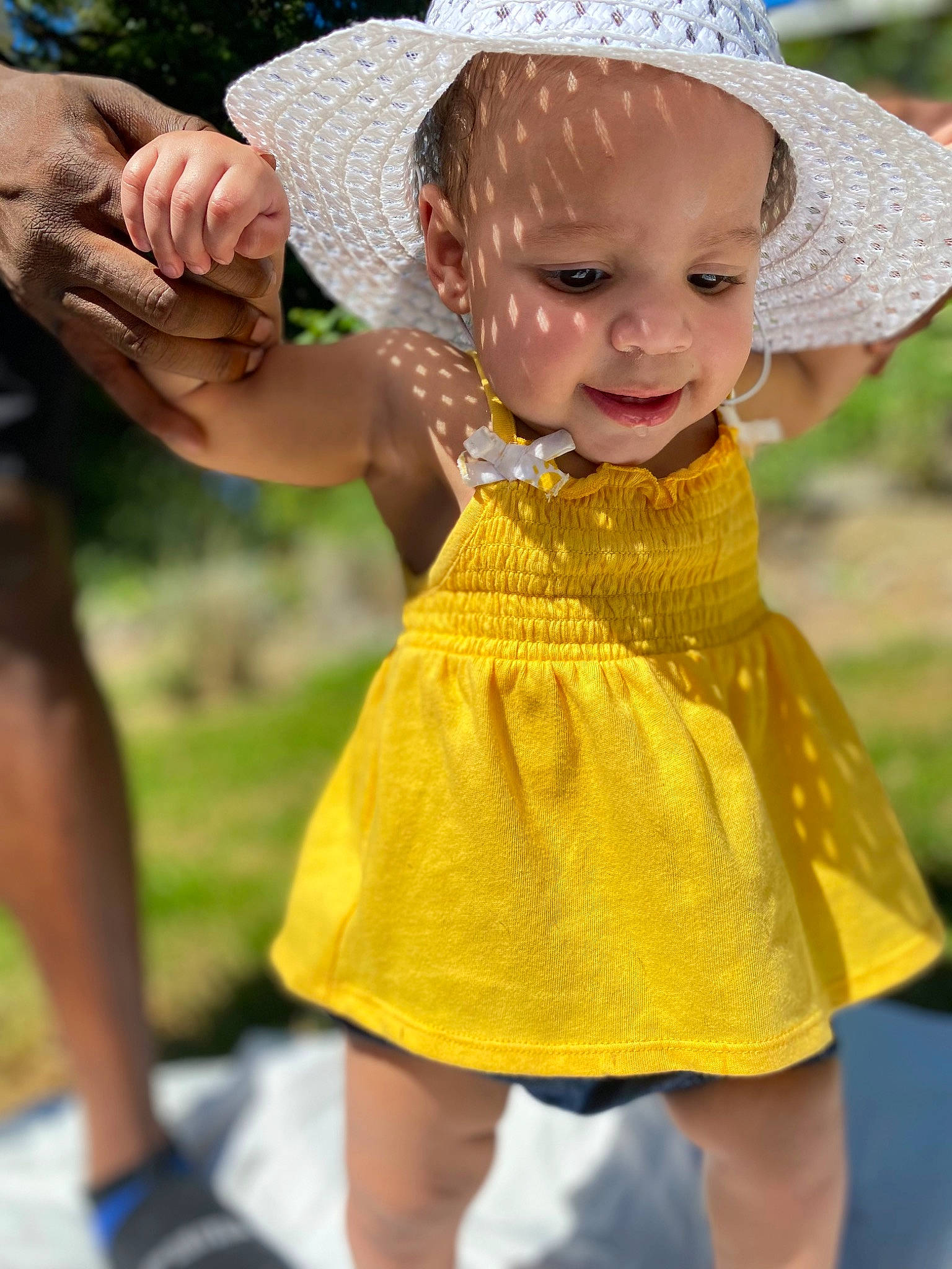 Gaia is registered to the contest to win money with this photo: baby_toddler_clothing, child, day_dress, dress, eye, fawn, fun, gesture, grass, green, hand, happy, hat, people_in_nature, person, photograph, plant, skin, summer, sun_hat