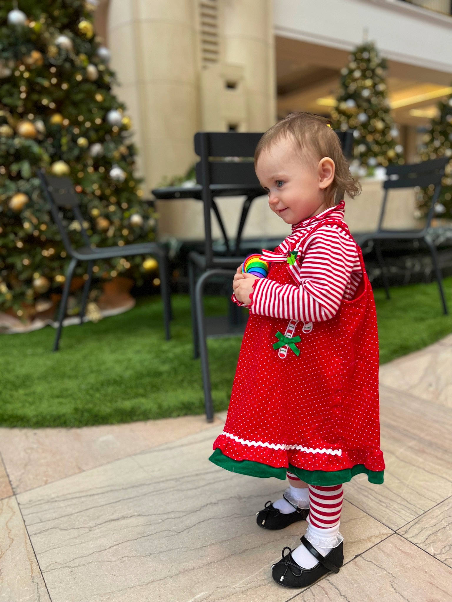 Aurora joined the competition — help win amazing prizes! baby, baby_toddler_clothing, christmas_ornament, christmas_tree, dress, event, flooring, holiday, holiday_ornament, pattern, people, person, plaid, plant, sleeve, snapshot, standing, toddler, tree, white