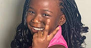 Wynter is registered to the contest to win money with this photo: black_hair, braided_hair, casual, chair, child, curly_hair, cute, dark_skin, face, girl, hand_gesture, happy, indoor, peace_sign, person, pink_clothing, portrait, seated, smile, young