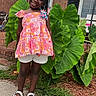 Wynter joined the competition — help win amazing prizes! beads, braids, brick_wall, child, door, floral_top, girl, grass, happy, leafy_plant, nature, outdoor, portrait, sandals, shoes, sidewalk, smile, summer, white_shorts, window