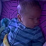 Sebastian is registered to the contest to win money with this photo: baby, sleeping, blanket, pajamas, child, infant, bed, rest, cozy, cute, face, peaceful, purple, striped_clothing, soft, young, indoors, comfort, nap, portrait