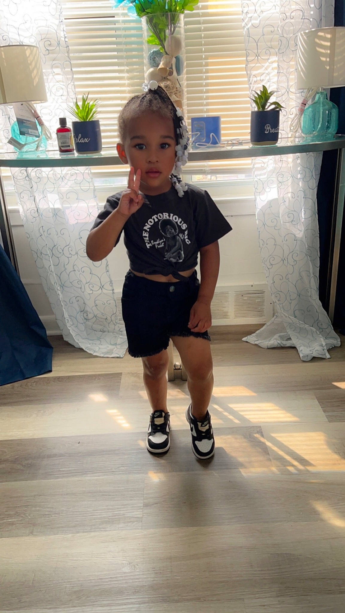 Cailey is registered to the contest to win money with this photo: child, elbow, electric_blue, floor, flooring, fun, happy, houseplant, human_leg, joint, knee, leisure, person, plant, shorts, sleeve, standing, t_shirt, thigh, toddler